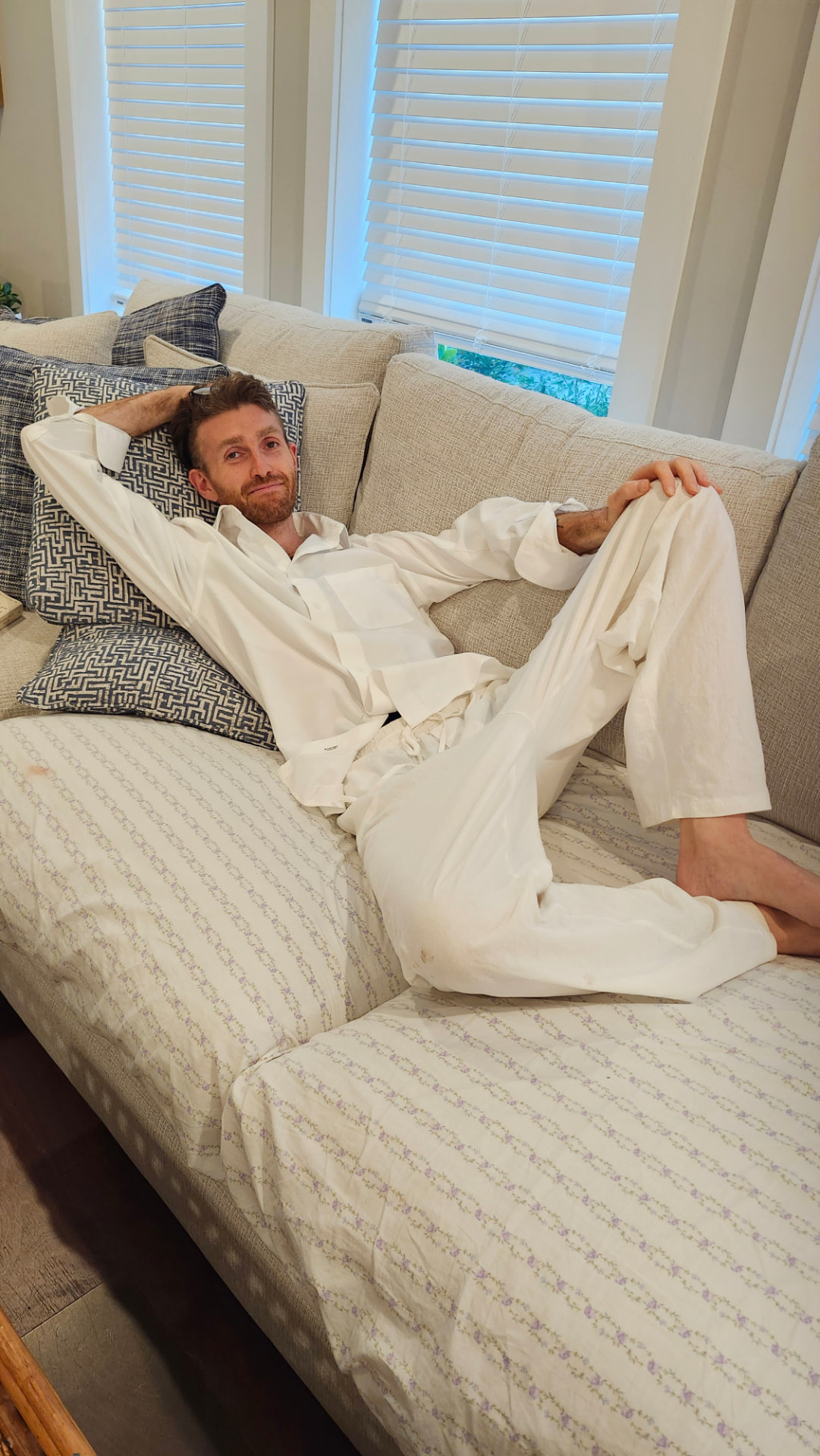 Bob after the initiation — short hair, dressed in white linen, resting peacefully